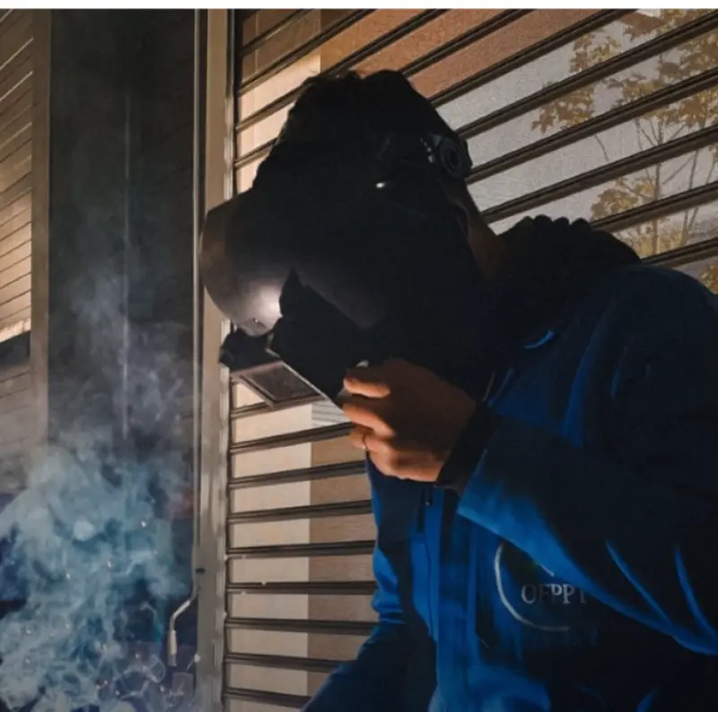 Welder at work on a factory floor